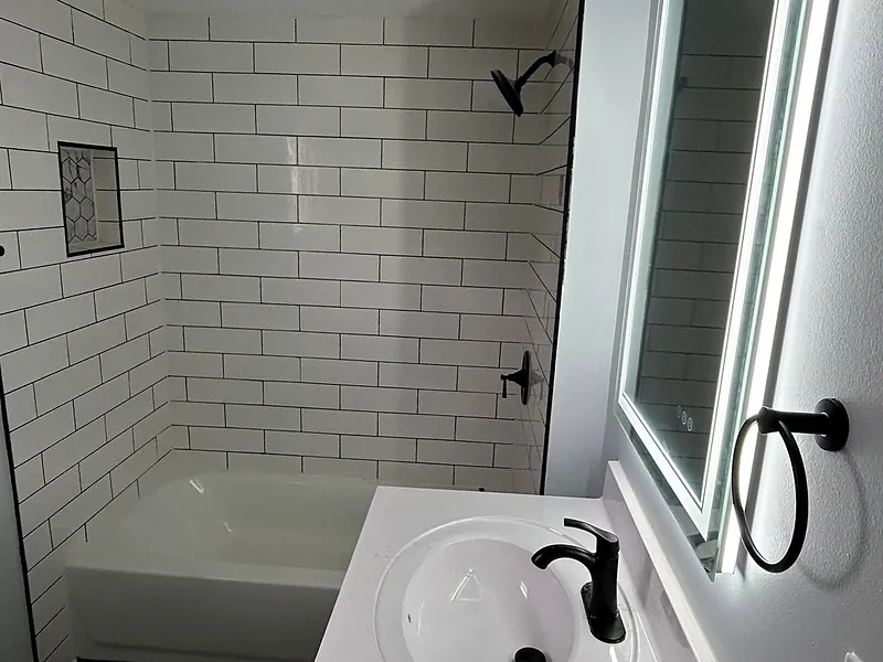 Remodeled bathroom with white subway tile